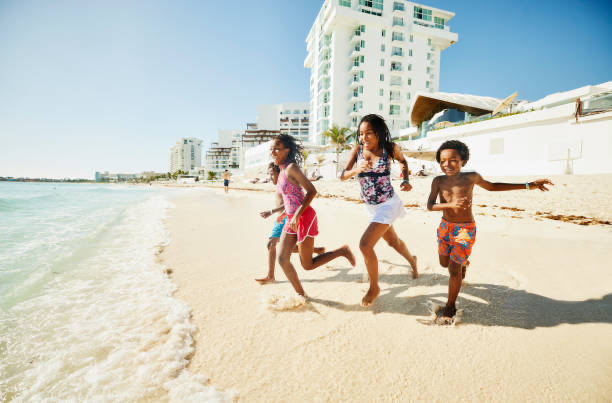 Kids running on resort beach